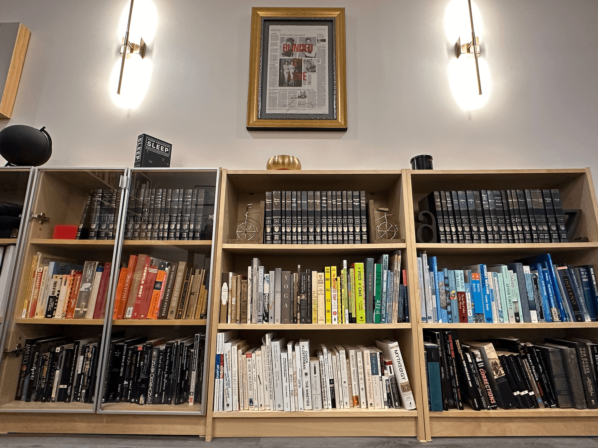 Wall of books and art objects in therapist Andi Grushka's office