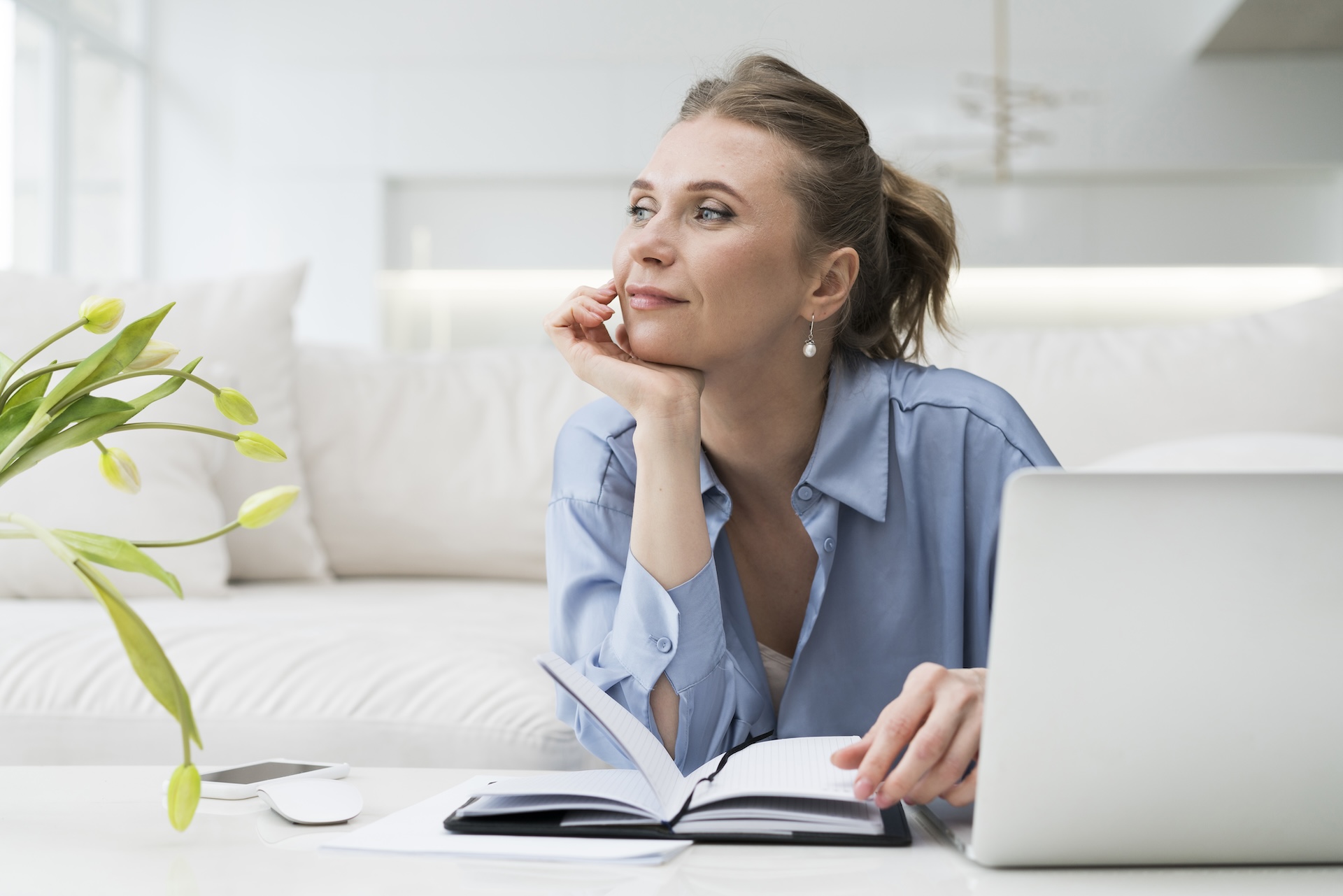 Woman taking notes while researching online about intimacy issues and sex therapy for couples